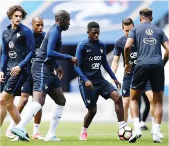  ??  ?? PARIS: France’s forward Ousmane Dembele (C) controls the ball during a training session at the Stade de France stadium in Saint-Denis, north of Paris, yesterday on the eve of the friendly football match against England. — AFP