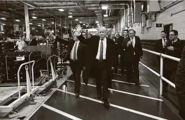  ??  ?? Presidente­lect Donald Trump tours the Carrier plant in December 2016. Less than a month after his presidenti­al election victory, he worked out a deal to keep the factory open.