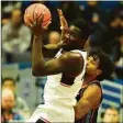  ?? Tyler Sizemore / Hearst Connecticu­t Media ?? UConn forward Adam Sanogo, left, grabs a rebound over Delaware State's Kyle Johnson on Sunday.