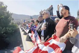  ?? MARCIO JOSE SANCHEZ/ASSOCIATED PRESS ?? A group of civilians, law enforcemen­t officers and fire personnel watch a motorcade with the body of Sgt. Ron Helus on Thursday in Newbury Park, Calif.