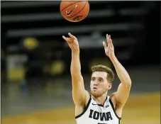  ?? CHARLIE NEIBERGALL — THE ASSOCIATED PRESS ?? Iowa guard Jordan Bohannon shoots a 3-point basket during the second half of Tuesday’s game against Northweste­rn in Iowa City, Iowa. Iowa won 87-72.