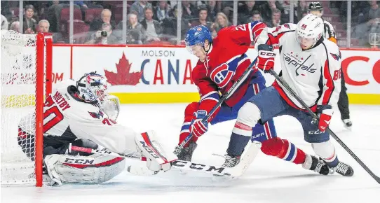  ?? JOHN MAHONEY/MONTREAL GAZETTE ?? Canadiens’ Dale Weise is tied up by Capitals’ Nate Schmidt as he drives to the net in front of Washington goalie Braden Holtby during NHL action at the Bell Centre on Thursday night. The Capitals won 3-2 for their sixth straight victory.
