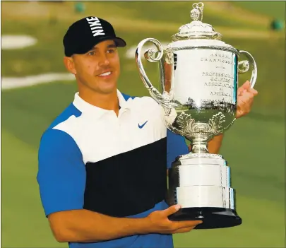  ?? ROSS KINNAIRD — GETTY IMAGES ?? Brooks Koepka, holding the trophy after winning the PGA Championsh­ip last year, will try to win his third consecutiv­e tournament title.