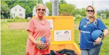  ?? JESSICA SMITH • CAPE BRETON POST ?? YMCA after-school program workers Karen Harriet, left, and April Madden, right, at one of the Busy Bees Playboxes, bins that are filled with toys for public use, in the Southend Public Gardens in Sydney.