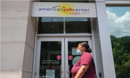  ?? Photograph: Saul Loeb/AFP/Getty Images ?? A woman walks past an employment center in Washington DC.