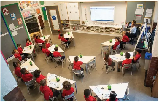  ?? Pictures: PA, REUTERS, EPA, AFP, ANDREW PARSONS/ 10 DOWNING STREET ?? Safety first... the new class layout at Charles Dickens Primary in London and, below, hand gels and wash basins