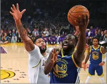  ?? MARK J. TERRILL — THE ASSOCIATED PRESS ?? Warriors forward Draymond Green, right, takes the ball to the basket against Lakers defender Anthony Davis in Wednesday’s preseason loss.