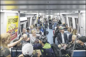  ?? DAVID BARNES / DAVID.BARNES@AJC.COM ?? Passengers ride a red line train at the North Springs MARTA Station in Atlanta on Friday. Many commuters are taking MARTA to counter road closures after the I-85 bridge collapse Thursday night.