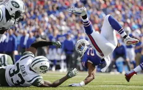  ?? ADRIAN KRAUS/THE ASSOCIATED PRESS ?? Buffalo’s LeSean McCoy is tackled by New York’s Jamal Adams on Sunday. McCoy ran for 110 yards, more than the Jets allowed per game last season.