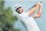  ?? AP ?? Dustin Johnson hits his tee shot on the 17th hole.