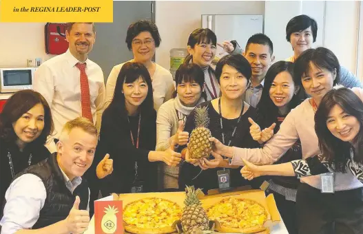  ?? CANADIAN TRADE OFFICE / FACEBOOK ?? Officials at the Canadian Trade Office in Taipei pose with pineapples and Hawaiian pizza this week after China banned imports of the fruit from Taiwan.