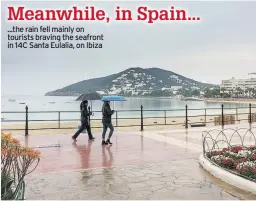  ??  ?? ...the rain fell mainly on tourists braving the seafront in 14C Santa Eulalia, on Ibiza Meanwhile, in Spain...