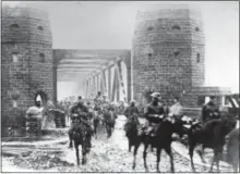  ?? PHOTO PROVIDED ?? U.S. Army National Guard soldiers assigned to the 165th Infantry Regiment, 42nd Division, pass through the Ludendorff Bridge at Remagen, Germany as they assume occupation duties on Dec. 13, 1918. The 42nd Division, known as the Rainbow Division for its inclusion of various National Guard units from across the United States, served as an occupation force in the Rhineland following the armistice that ended World War I. The division served in Germany until April 1, 1919when it embarked for its journey home.