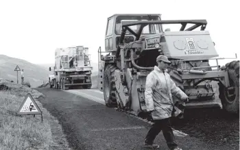  ?? 01_B09twe03 ?? Perhaps the largest roadbuildi­ng machines ever to visit Arran are working away on the top of the String Road this week. The resurfaced road will be open to traffic by this weekend.