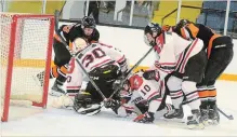  ?? BERND FRANKE THE ST. CATHARINES STANDARD ?? Thorold goaltender Chase Grsic isn't alone scrambling for a loose puck in Greater Ontario Junior Hockey League action versus Fort Erie Thursday.