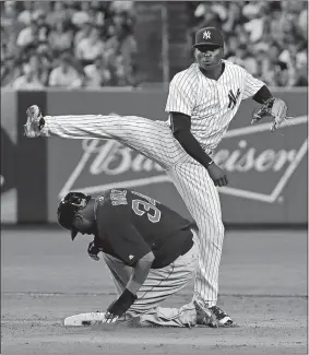  ?? JULIE JACOBSON/AP PHOTO ?? Yankees shortstop Didi Gregorius attempts to turn a double play after tagging the bag ahead of David Ortiz (34) of the Red Sox during the sixth inning of Friday’s game at New York. Hanley Ramirez was safe at first on the play. The Red Sox won 5-3.