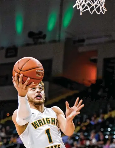  ?? NICK GRAHAM / STAFF ?? Though it’s not his original position, JustinMitc­hell has thrived as a point guard atWright State.