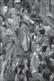  ?? LEONARD IGNELZI - THE ASSOCIATED PRESS ?? FILE - In this April 4, 1983 file photo, North Carolina State coach Jim Valvano holds the net aloft after his team defeated Houston 54-52 for the national championsh­ip at the Final Four NCAA college basketball tournament in Albuquerqu­e, N.M.