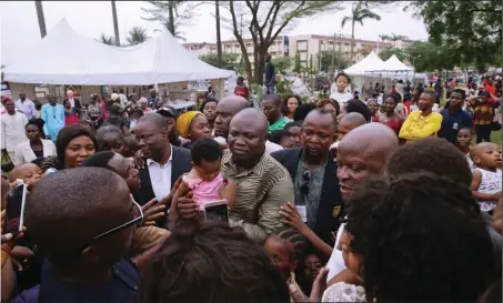  ??  ?? Lagos State Governor, Mr. Akinwunmi Ambode (middle), with a baby and fun seekers who thronged the JJT Park, Alausa, Ikeja for the Easter celebratio­n....yesterday