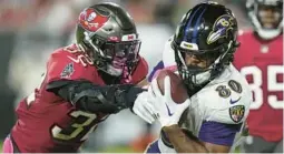  ?? CHRIS O’MEARA/AP ?? Ravens tight end Isaiah Likely catches a touchdown pass as Buccaneers safety Mike Edwards (32) defends during the second half of the Ravens’ victory on Oct. 27 in Tampa, Fla.