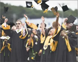  ?? Catherine Avalone / Hearst Connecticu­t Media ?? John Fowler, Priya Gupta, salutatori­an GraceAnne Piselli and valedictor­ian Oreoluwato­miwa Opayemi throw their caps in the air at Jonathan Law High School graduation Wednesday in Milford.