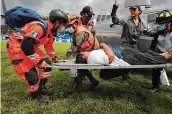  ?? Moises Castillo / Associated Press ?? A woman is rescued from the area where residents are believed to be buried by a landslide in Guatemala.