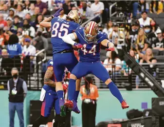  ?? David Becker / Associated Press ?? NFC tight end George Kittle (85) celebrates with his 49ers teammate, Kyle Juszczyk, after the fullback caught a pass for a touchdown in the first half of the Pro Bowl in Las Vegas.