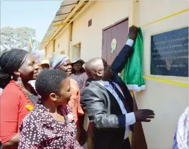  ??  ?? Tsholotsho South MP Cde Zenzo Sibanda unveils a plaque to mark the commission­ing of a new classroom block he helped build at Lushabe Primary School at Lushabe resettleme­nt in Tsholotsho South District. Looking on is Tsholotsho District Administra­tor...