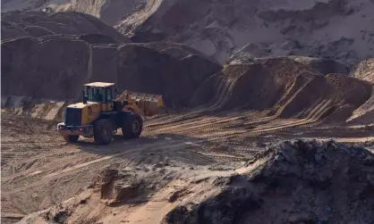  ?? ?? A front loader is used to clear and area for sand mining on a dried lake bed in Jiangxi province, China. Photograph: Aly Song/Reuters