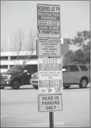  ?? NWA Democrat-Gazette/ANDY SHUPE ?? A sign explaining parking enforcemen­t instructio­ns stands Saturday in Lot 71 on the University of Arkansas campus in Fayettevil­le. The university announced plans a year ago to begin using car-mounted cameras to enforce parking regulation­s, but the system has not been installed despite records showing nearly $300,000 made in payments to NuPark.