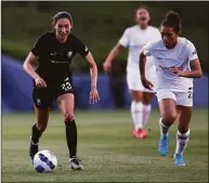  ?? Katharine Lotze / Getty Images ?? Christen Press of Angel City moves the ball down the field ahead of Yazmeen Ryan of the Portland Thorns during a game as part of the 2022 NWSL Challenge Cup at Titan Stadium on Sunday in Fullerton, Calif.