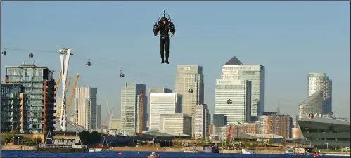  ??  ?? Ready for take-off: David Mayman prepares for his flight, then soars up to 100ft over the Thames