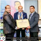  ??  ?? Outgoing President Rtn. Somindra Gunawardha­na handing over the charter certificat­e to the President elect Dilshan Perera for the term 2020-21 in the presence of District Governor Rtn. Ajith Weerasingh­e.