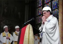  ?? Karine Perret/Associated Press ?? Archbishop of Paris Michel Aupetit celebrates the first Mass at Notre Dame Cathedral since a fire engulfed the beloved Paris house of worship. Story on