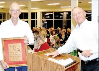  ?? PHOTO BY RICK PECK ?? Don Underwood, left, accepts the Heart of Education Award on behalf of his family from Randy Smith, secretary of the McDonald County Schools Foundation.