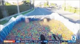  ?? KTLA-TV ?? A VIDEO shows a boy and a woman submerged in Orbeez gel beads in Corona. Holly Piazza and Brian Chase were cited on suspicion of child endangerme­nt.