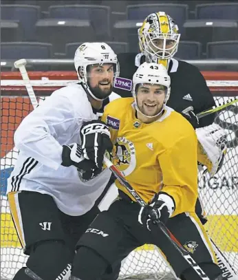  ??  ?? Brian Dumoulin, left, works against Conor Sheary Saturday as the Penguins practiced in Washington.