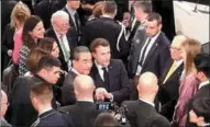  ?? PROVIDED TO CHINA DAILY ?? State Councilor and Foreign Minister Wang Yi (center) meets with French President Emmanuel Macron on the sidelines of the 56th Munich Security Conference on Saturday. Wang called at the conference for transcendi­ng East-West and North-South difference­s and practicing multilater­alism.