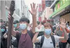  ?? TANG YAN TRIBUNE NEWS SERVICE ?? Protesters gesture with five fingers raised, signifying five demands, in Hong Kong on Wednesday.