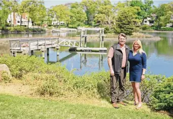  ?? Tyler Sizemore/Hearst Connecticu­t Media ?? Mark Marache, left, and Marti Marache pose by the dock on the shore of their property in the Riverside section of Greenwich on Monday, May 8.