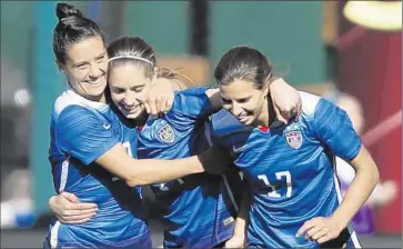  ?? Jeff Roberson Associated Press ?? MORGAN BRIAN, center, is among a group of talented young players joining veterans such as Ali Krieger, left, and Tobin Heath on the U.S. women’s soccer World Cup team. Brian, 22, is the youngest team member.