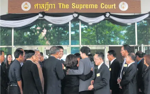  ?? PATTARAPON­G CHATPATTAR­ASILL ?? Ousted prime minister Yingluck Shinawatra, centre, appears at the Supreme Court in July for a witness hearing session in the malfeasanc­e case in which she is alleged to have failed to prevent damage and irregulari­ties in the rice-pledging scheme.