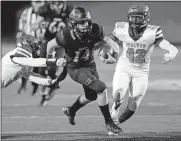  ?? BILLINGS/ THE OKLAHOMAN] ?? Norman's Cade Horton, center, runs from Edmond Santa Fe's Austin Roat, left, and Michael Pope last season. [NATE