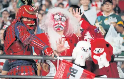  ??  ?? LEFT
Japan fans watch their team play against South Africa.