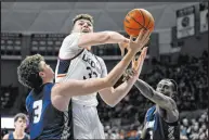  ?? Jessica Hill The Associated Press ?? Connecticu­t center Donovan Clingan battles against New Hampshire forward Clarence Daniels in the Huskies’ 84-64 win.