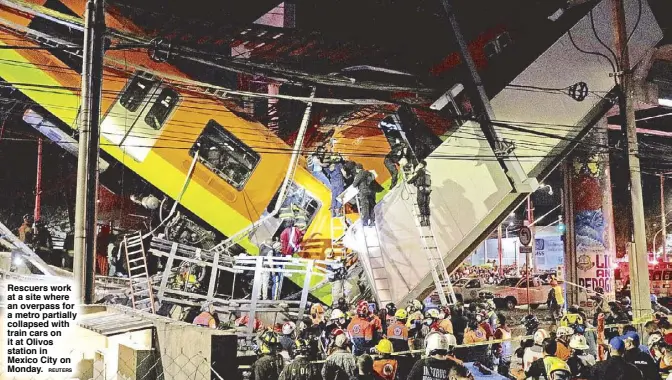  ?? REUTERS ?? Rescuers work at a site where an overpass for a metro partially collapsed with train cars on it at Olivos station in Mexico City on Monday.