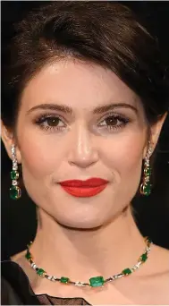  ??  ?? BOND Girl Gemma Arterton, 32, injected a burst of colour with these gold and emerald earrings — and matching necklace — by Brazilian Ara Vartanian. Ara, a favourite of Kate Moss, owns a Mayfair boutique and specialise­s in unusual, eye-catching pieces....