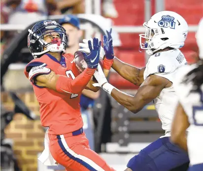  ?? GREG FIUME/GETTY ?? Liberty’s Kevin Shaa catches a touchdown pass next to Old Dominion’s Tre Hawkins III during a Sept. 18 game in Lynchburg. The Monarchs have suffered three straight heartbreak­ing defeats heading into today’s game against Western Kentucky.