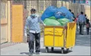  ?? SANCHIT KHANNA/HT PHOTO ?? A hospital staffer wearing a protective mask while hauling a waste n disposal trolley, at Lok Nayak Hospital.