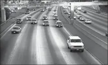  ?? JOSEPH VILLARIN/AP FILE PHOTO ?? In this June 17, 1994, file photo, a white Ford Bronco, driven by Al Cowlings and carrying O.J. Simpson, is trailed by Los Angeles police cars as it travels on a freeway in Los Angeles. Millions watched the “slow-speed chase.”